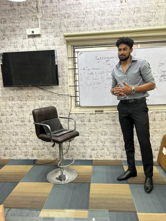 Trainer speaking at the whiteboard during a session at the Change Institutes centre
