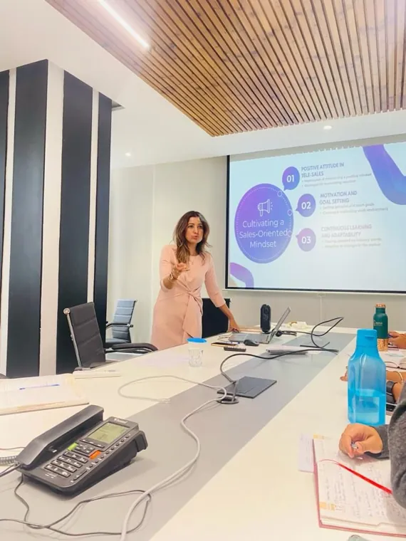 Trainer presenting slides to a team in a boardroom
