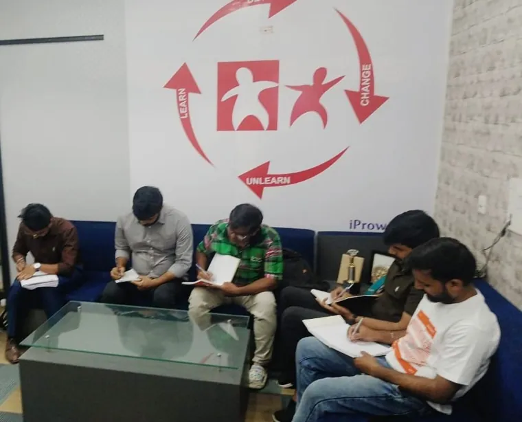 Participants working through a written exercise on the sofa
