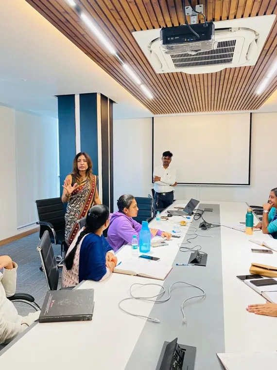 Team session in progress around a long boardroom table