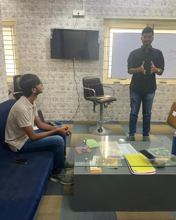 Trainer explaining a point to a participant one to one